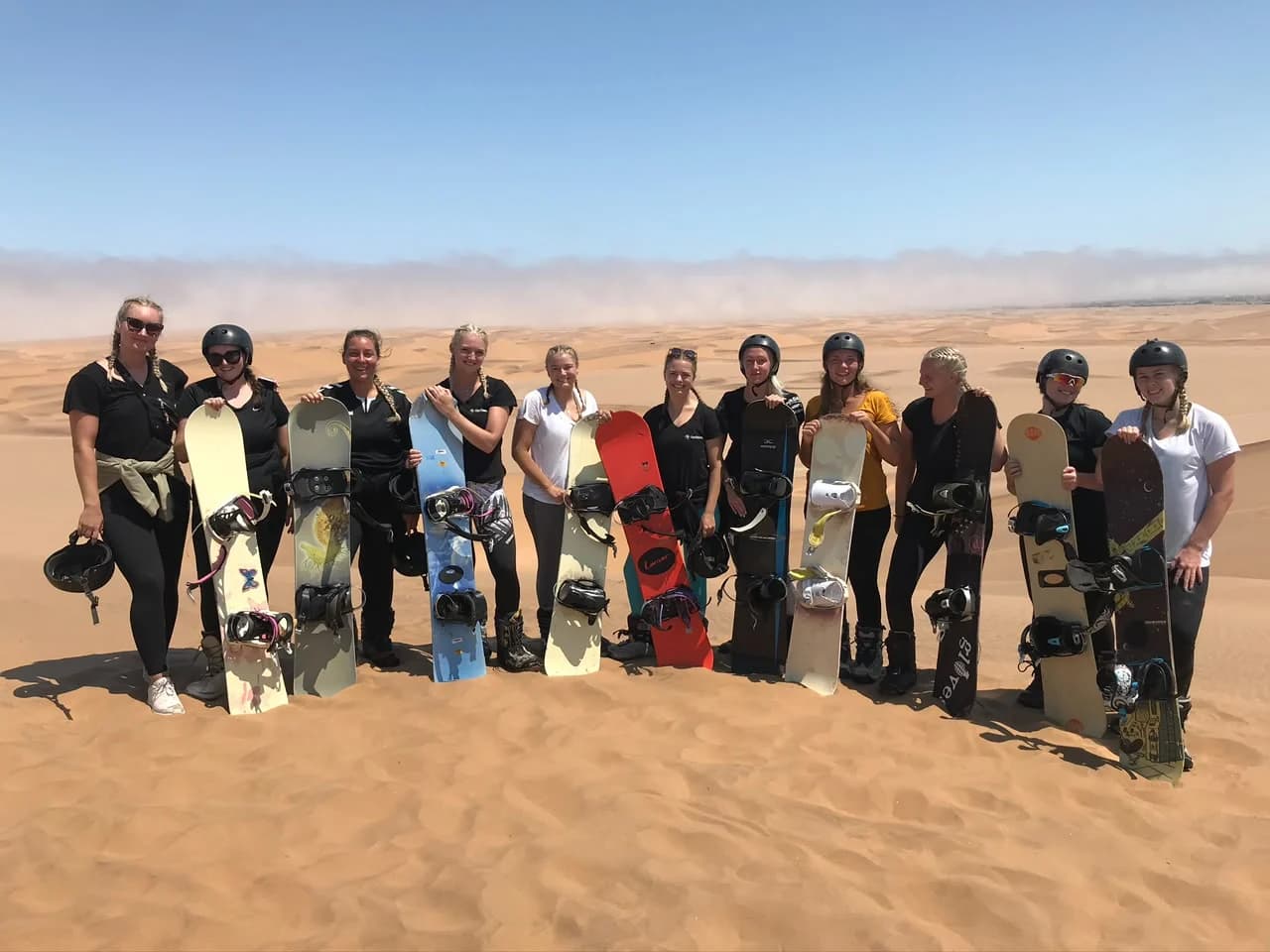 A group preparing to go sandboarding