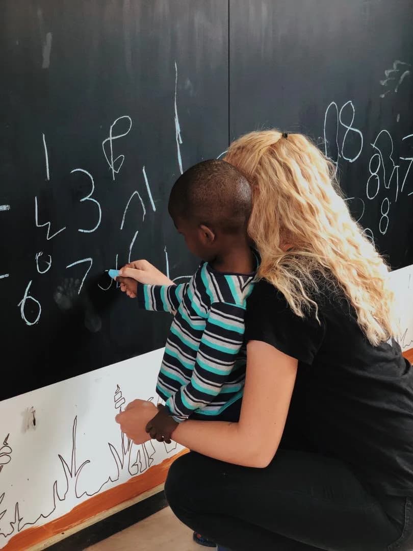 A student supporting a classroom activity