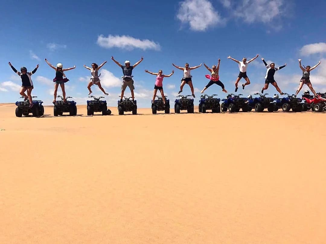 A group celebrating a day in the dunes